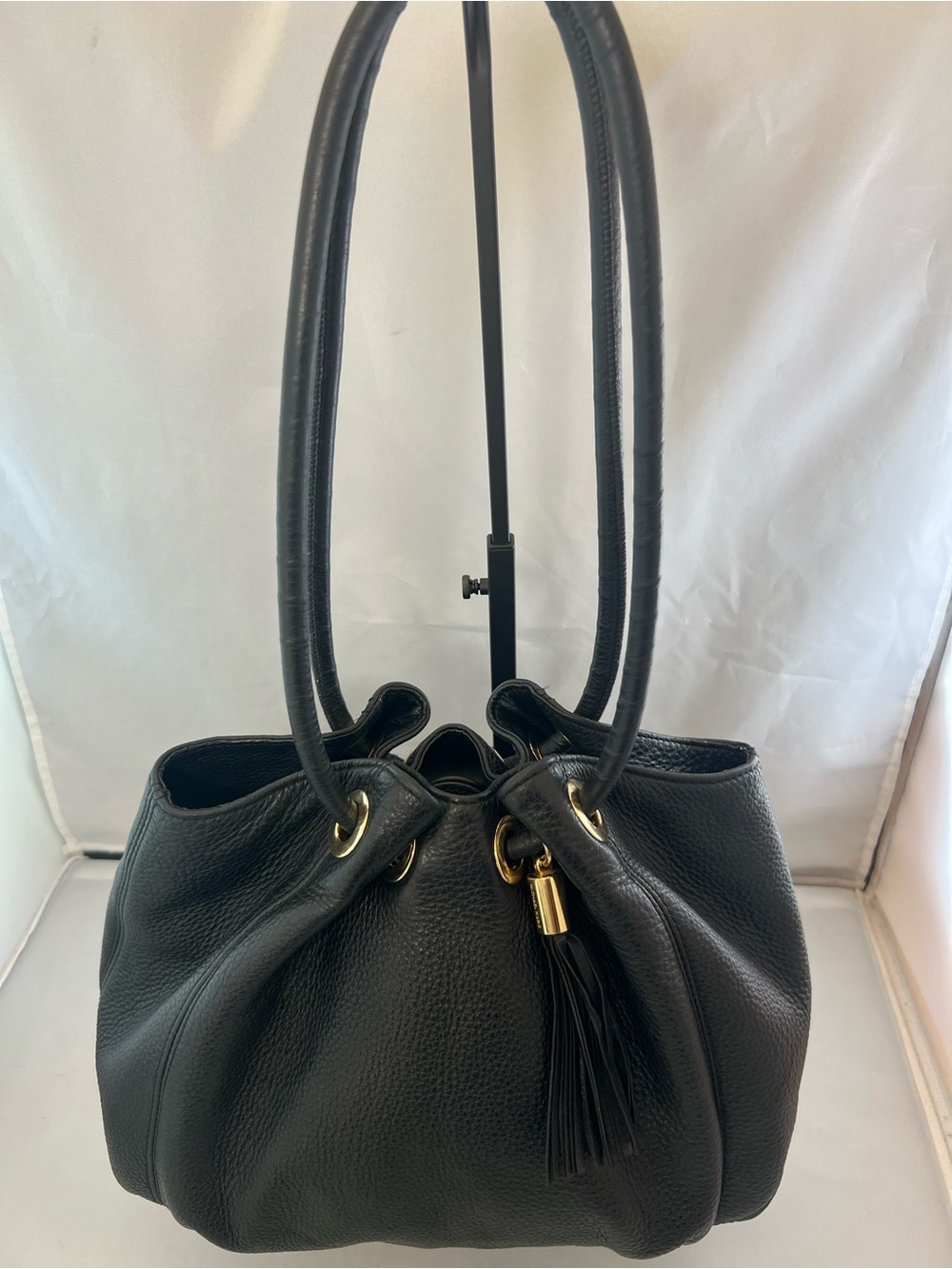 Michael Kors black pebbled leather bag with tassel.